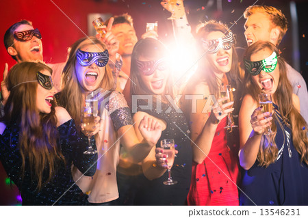 Friends in masquerade masks drinking champagne Friends in masquerade masks drinking champagne 13546231