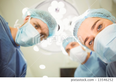 Team of surgeons working together 13546252