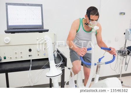 Man doing fitness test on exercise bike 13546382