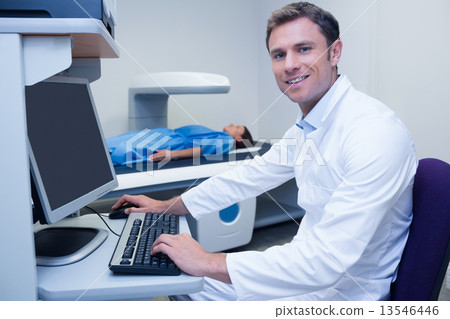 Portrait of a smiling doctor in radiography room 13546446