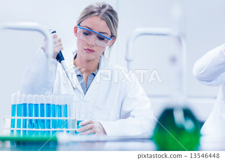 Science student using pipette in the lab Science student using pipette in the lab 13546448