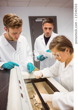 Science students using incubator in the lab 13546503