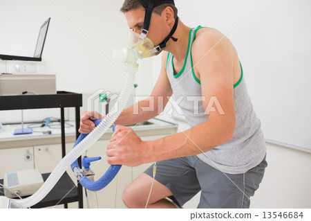 Man doing fitness test on exercise bike 13546684
