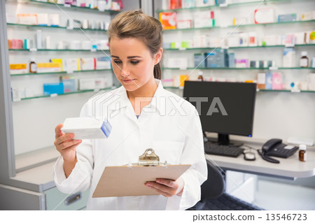 Junior pharmacist holding medicine box Junior pharmacist holding medicine box 13546723