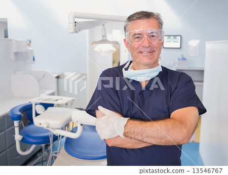 Portrait of a smiling dentist with arms crossed 13546767