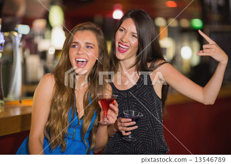 Pretty friends drinking cocktails together Pretty friends drinking cocktails together 13546789