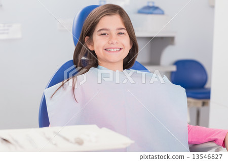 Smiling young patient sitting in dentists chair 13546827