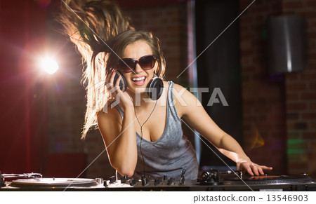 Pretty dj smiling and dancing 13546903