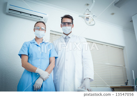 Portrait of dentists wearing surgical masks 13547056