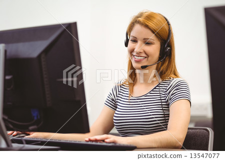 Student sitting at the computer room wearing headset Student sitting at the computer room wearing headset 13547077