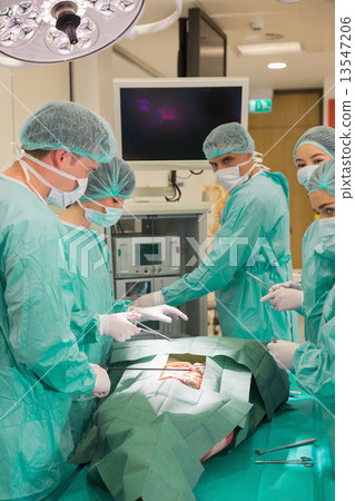 图库照片: medical students practicing surgery on model