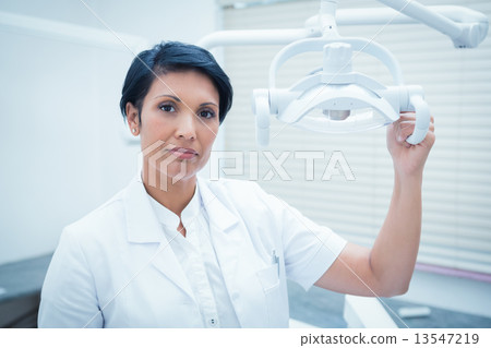 Confident female dentist 13547219