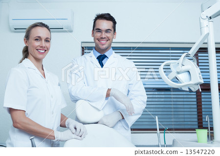Portrait of smiling dentists 13547220