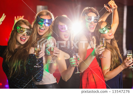 Friends in masquerade masks drinking champagne Friends in masquerade masks drinking champagne 13547276