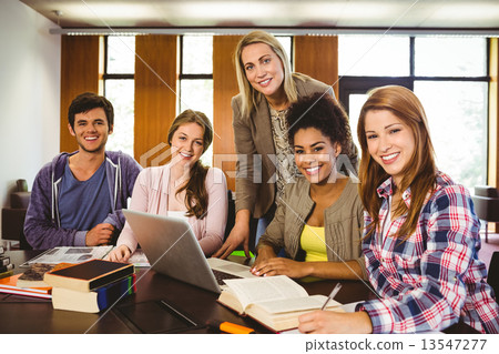 Student smiling at the camera with their teacher Student smiling at the camera with their teacher 13547277