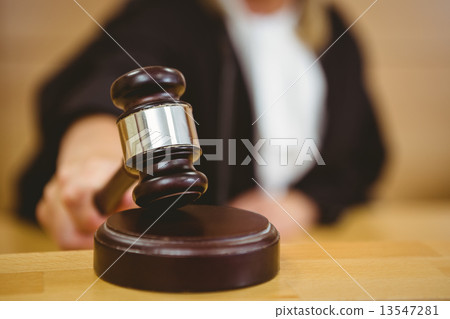 Hand about to bang gavel on sounding block Hand about to bang gavel on sounding block 13547281
