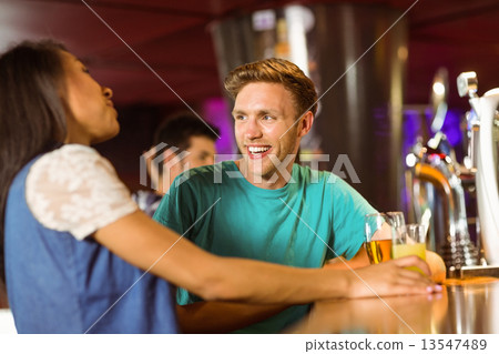 Smiling friends talking and drinking beer and mixed drink Smiling friends talking and drinking beer and mixed drink 13547489
