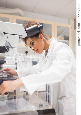 Pretty science student using microscope Pretty science student using microscope 13547498