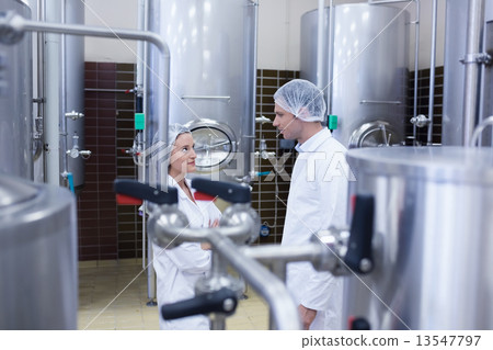 Biologist team talking and wearing hairnet 13547797
