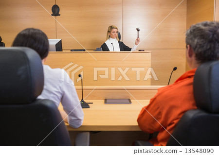 Lawyer and client listening to judge 13548090