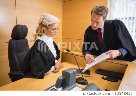 Lawyer speaking with the judge 13548435