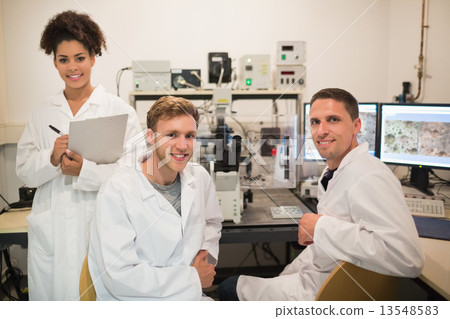 Biochemistry students using large microscope and computer Biochemistry students using large microscope and computer 13548583
