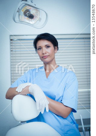 Serious young female dentist 13548670