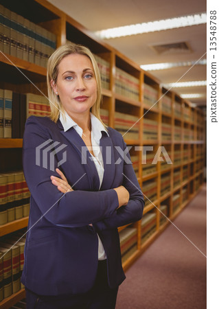 Serious woman standing with arms crossed Serious woman standing with arms crossed 13548788