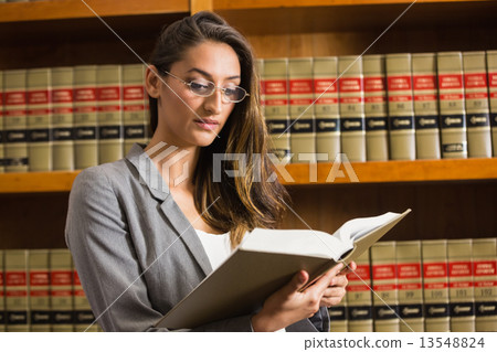 Pretty lawyer reading in the law library Pretty lawyer reading in the law library 13548824