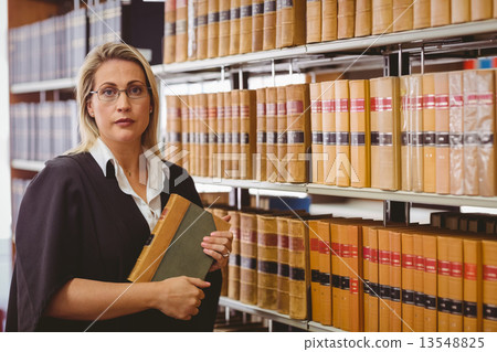 Serious lawyer holding a book Serious lawyer holding a book 13548825