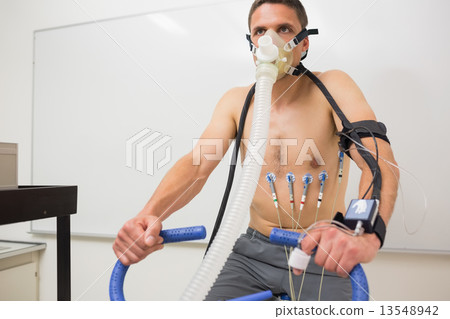 Man doing fitness test on exercise bike 13548942