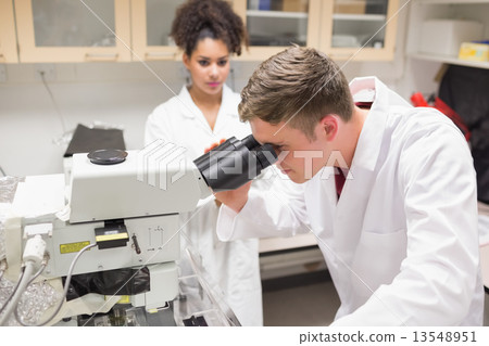 Young scientist working with microscope Young scientist working with microscope 13548951