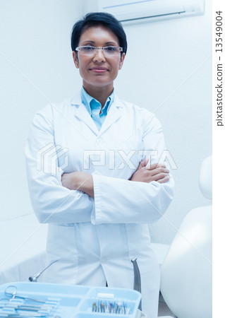 Portrait of confident female dentist 13549004