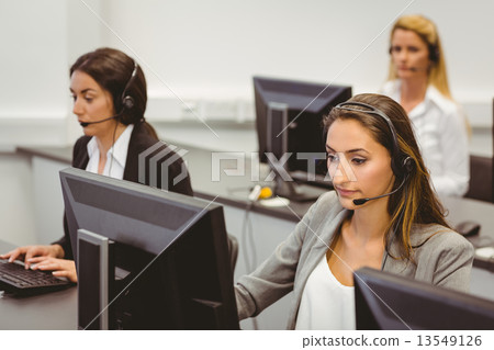 Call centre agents talking on the headset Call centre agents talking on the headset 13549126