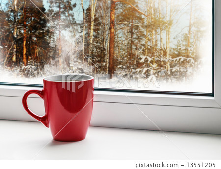 red cup of coffee on the windowsill 13551205