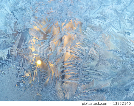 Ice pattern and sunlight on winter glass Ice pattern and sunlight on winter glass 13552140