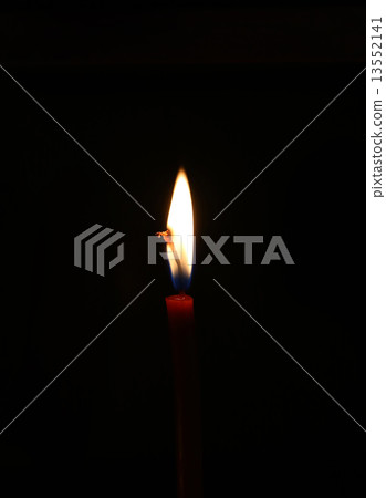 Burning candle in the dark Burning candle in the dark 13552141