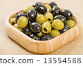 Olives - Bowl of pitted black and green olives.  13554588