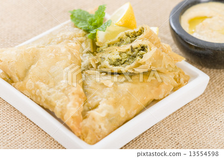Borek - Middle Eastern spinach and cheese stuffed pastry served with hummus and lemon wedges. 13554598