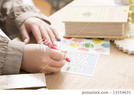 A woman writing sundries and a postcard 13554635