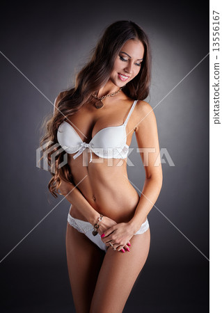 Smiling busty woman posing in white underwear 13556167