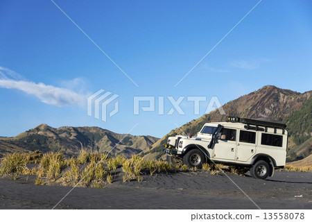 Jeep at foot of mountain 13558078