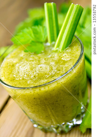 Cocktail with celery stalks in glassful on board Cocktail with celery stalks in glassful on board 13558792