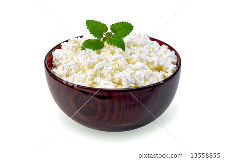 Curd in wooden bowl with mint 13558855