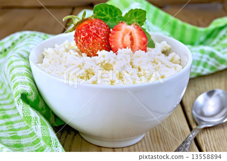 Curd with strawberries in white bowl on board 13558894