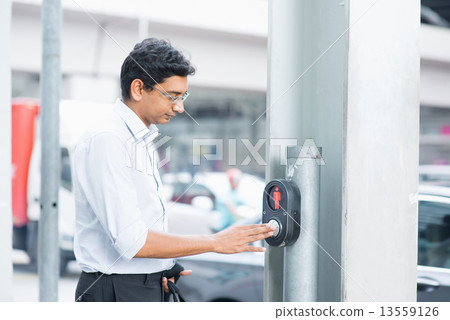 Indian people hand pushing a crosswalk button 13559126