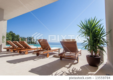Luxury swimming pool and deck chair 13559784