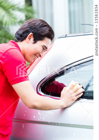 Asian man cleaning and washing car with sponge 13561934