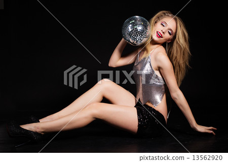 Fashion girl with disco ball over black background Fashion girl with disco ball over black background 13562920