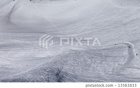 Skiers and snowboarders on off-piste slope in sun day 13563833